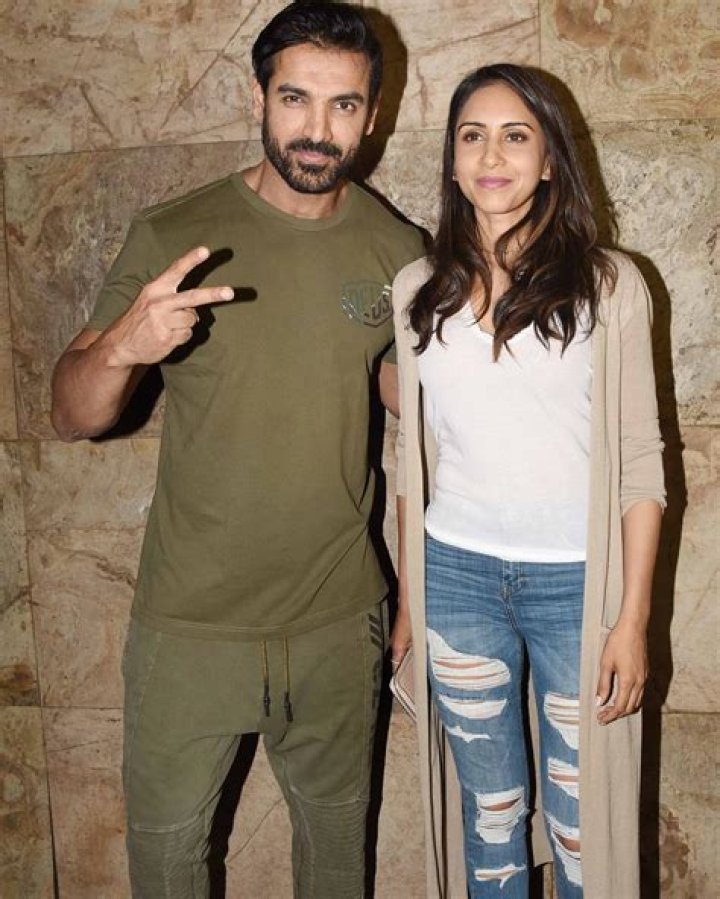 Priya Runchal posing for the camera alongside John Abraham in February 2019