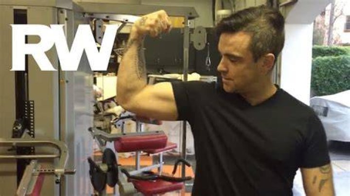 Robbie Williams showing his biceps