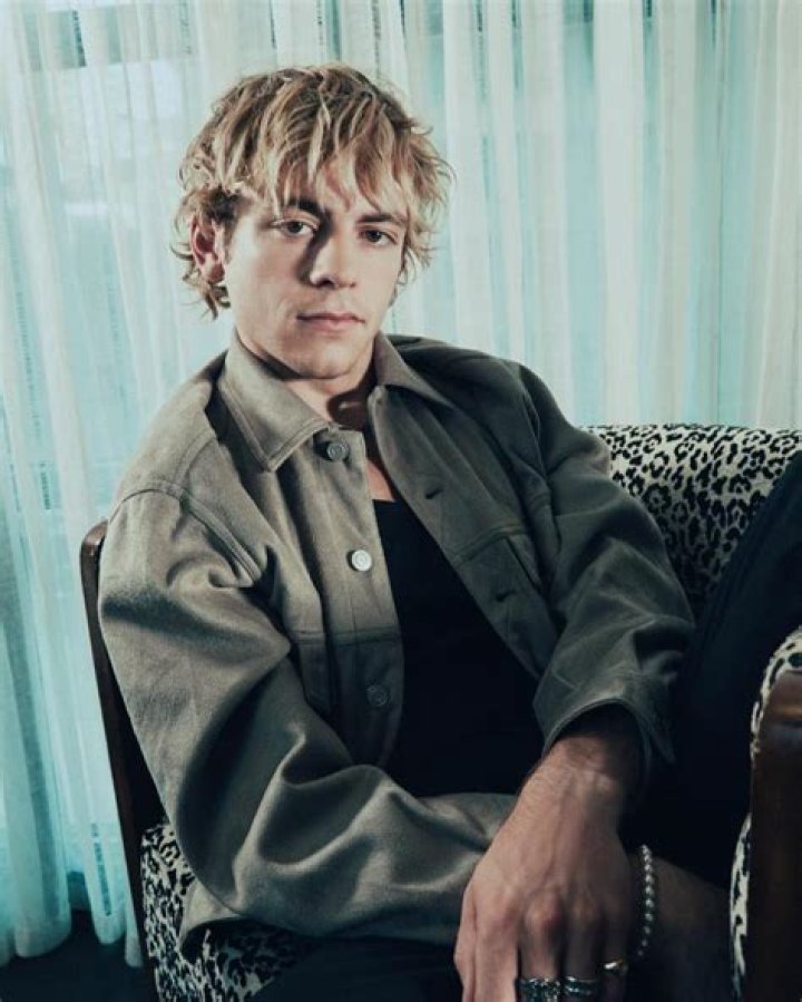 Ross Lynch sitting on the couch or sofa.