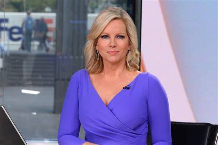Shannon Bream as seen while smiling for a picture showing her necklace in February 2020
