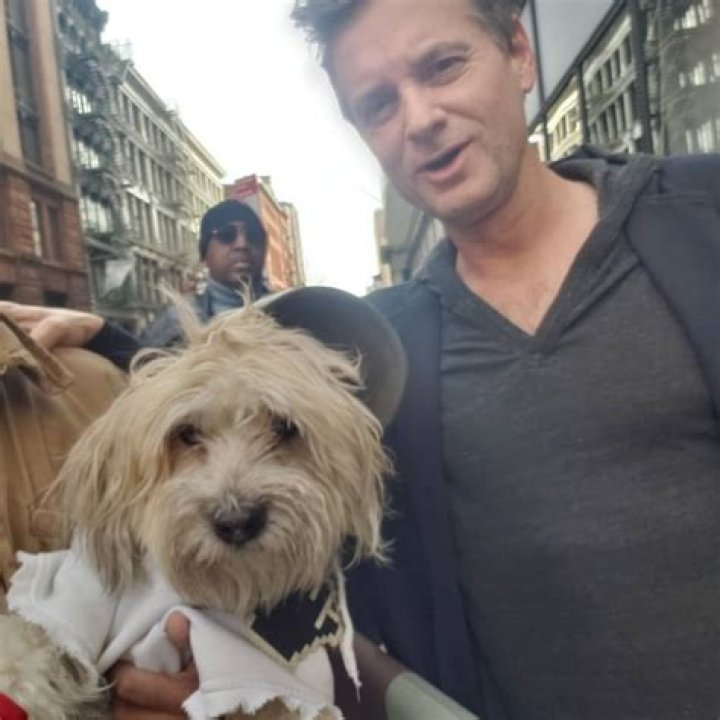 Shea Whigham posing with Coqui /Shaggy, the Maltipoo, in February 2019