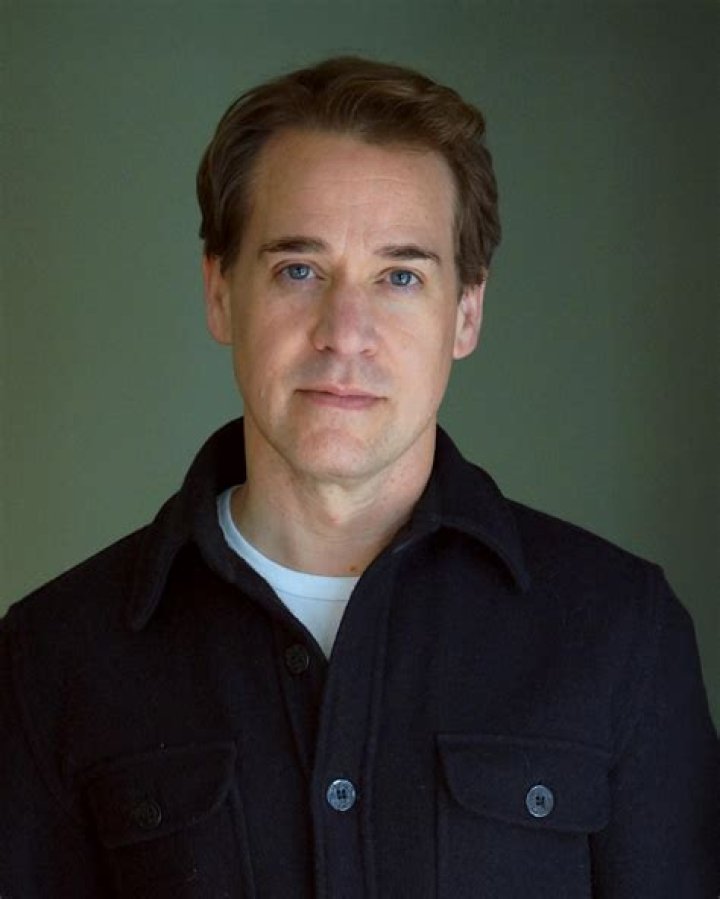 T. R. Knight smiling for a picture along with Kaley Cuoco in November 2020