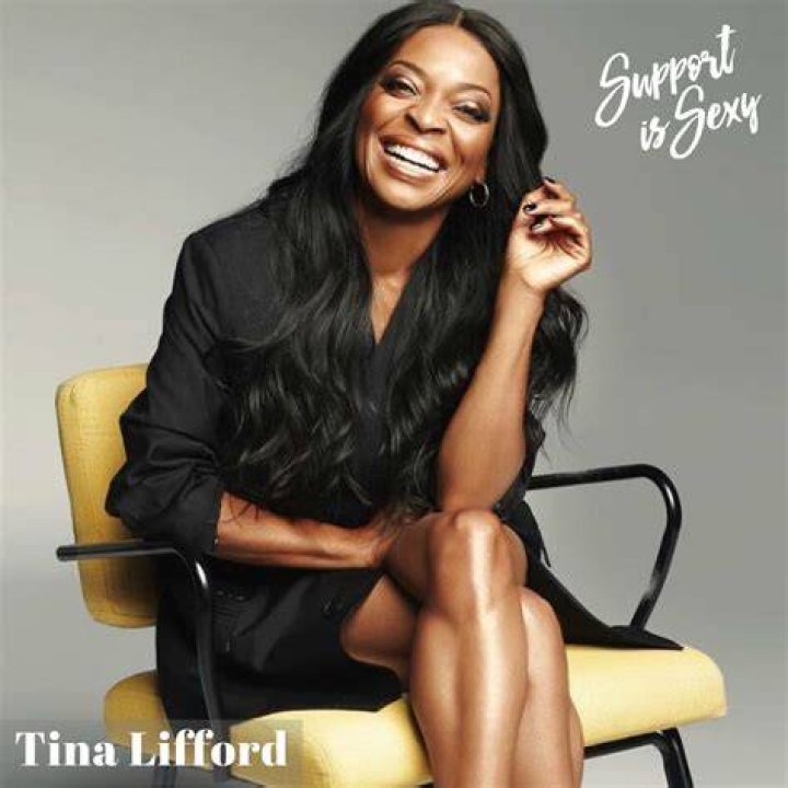 Tina Lifford smiling in a picture with a dog in December 2021