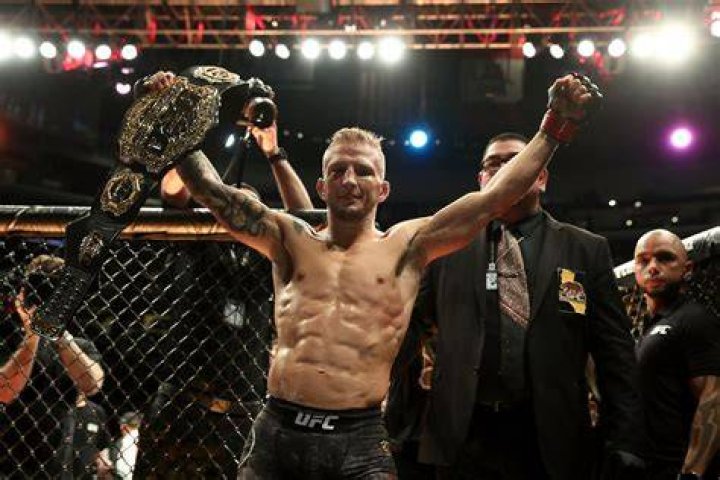 TJ Dillashaw posing with the American flag