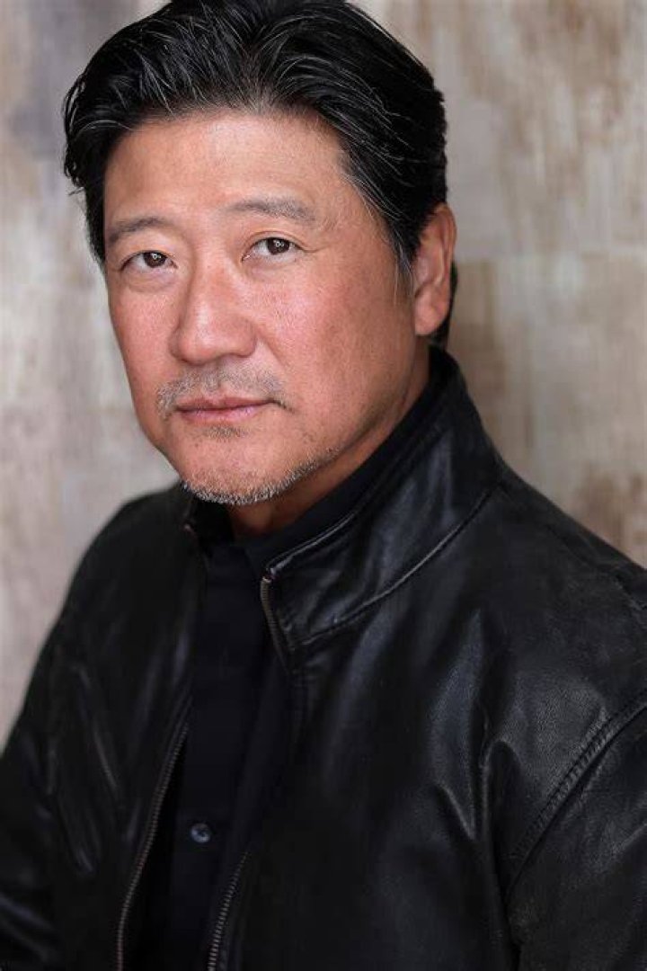 Tom Choi as seen while taking a selfie with his surfing board in the background at Bolsa Chica State Beach in California in March 2020