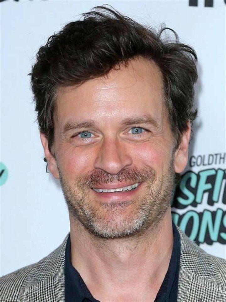 Tom Everett Scott smiling for a picture alongside Emma Stone in September 2015