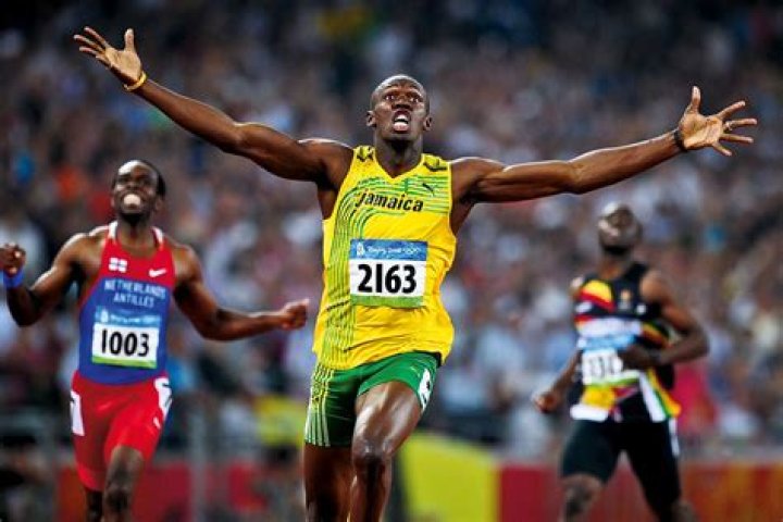 Usain Bolt working out his legs on "Leg Press" machine in the gym.