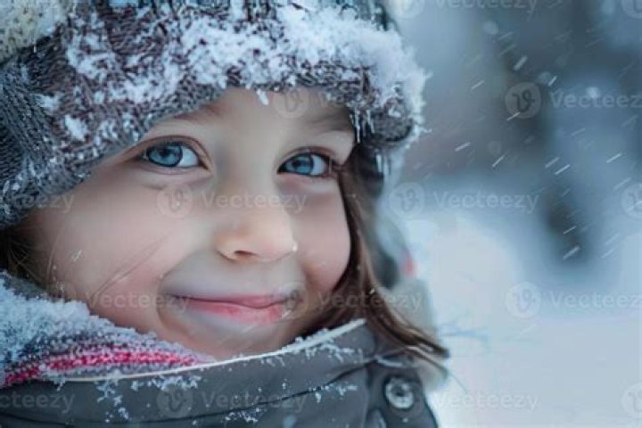 Winter as seen while smiling for a picture with a beautiful backdrop